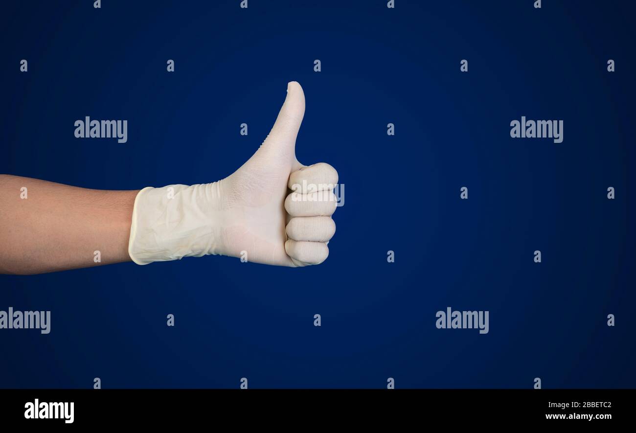 Doctor hand with glove showing like gesture or thumb up as approval, accept or done concept Stock Photo