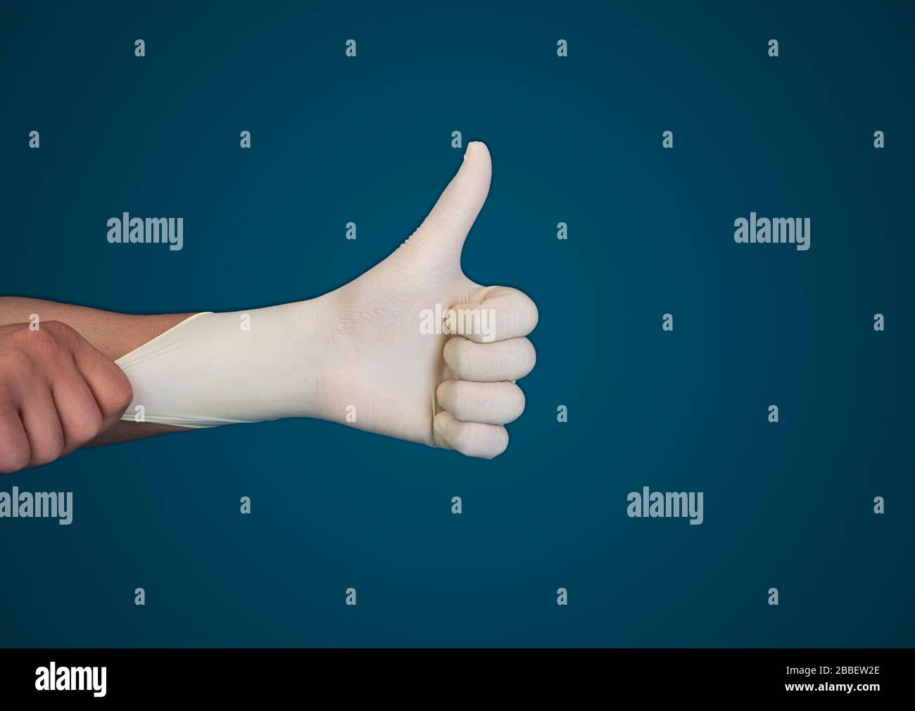 Doctor hand with glove showing like gesture or thumb up as approval, accept or done concept Stock Photo