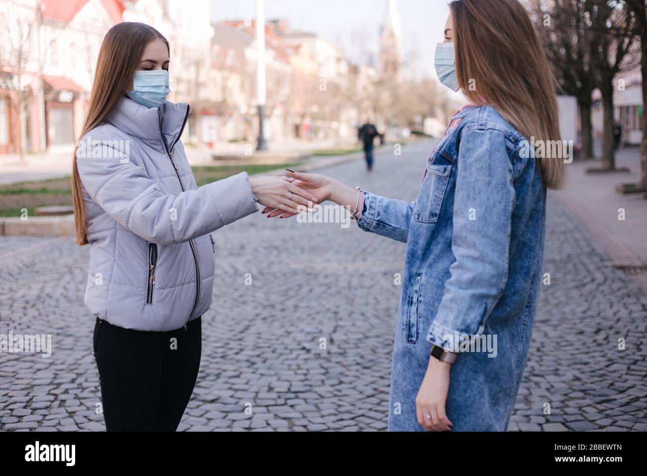 Girls in masks. Coronavirus theme. Women in the city walks during ...