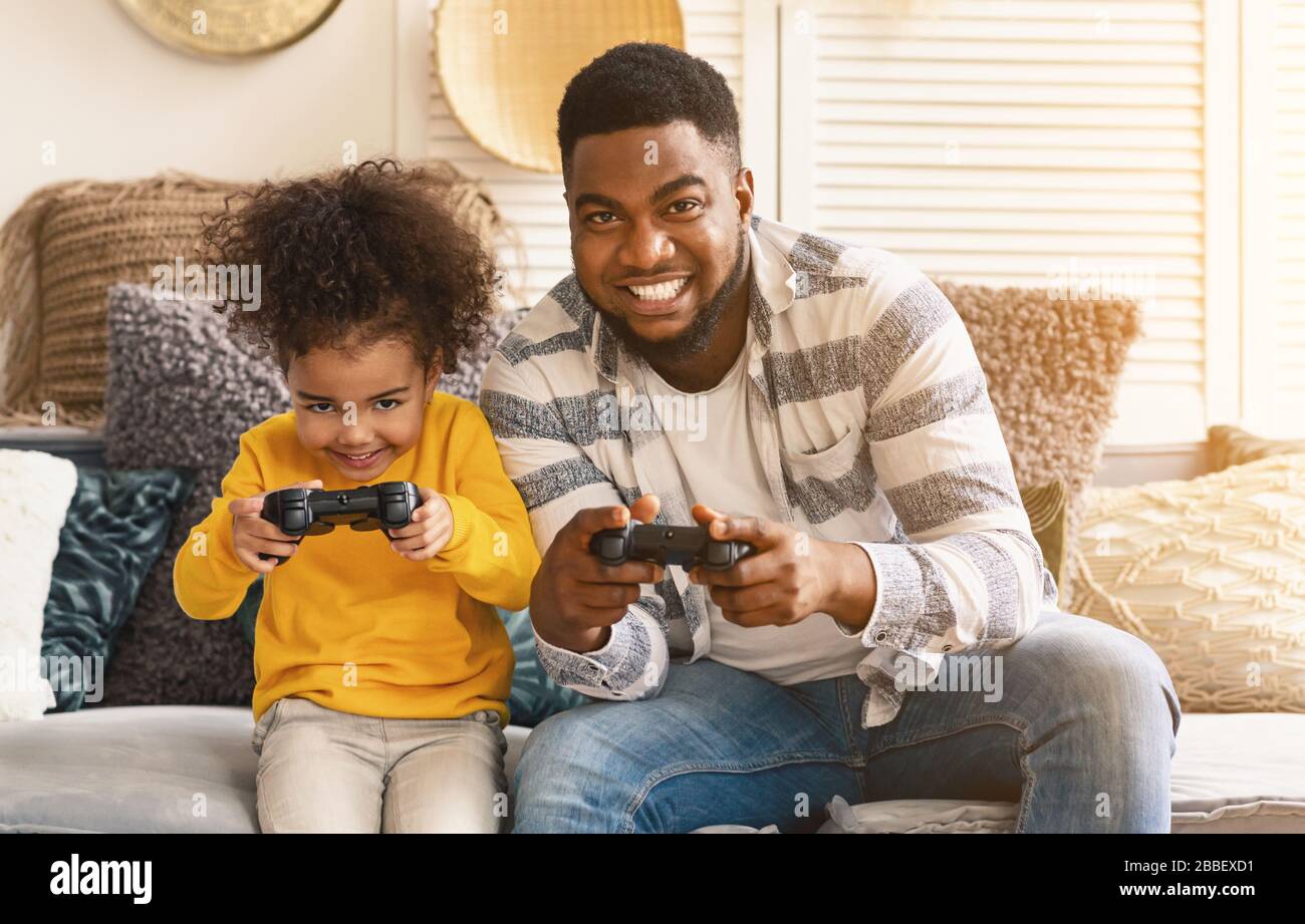 African american father and daughter play computer games Stock Photo