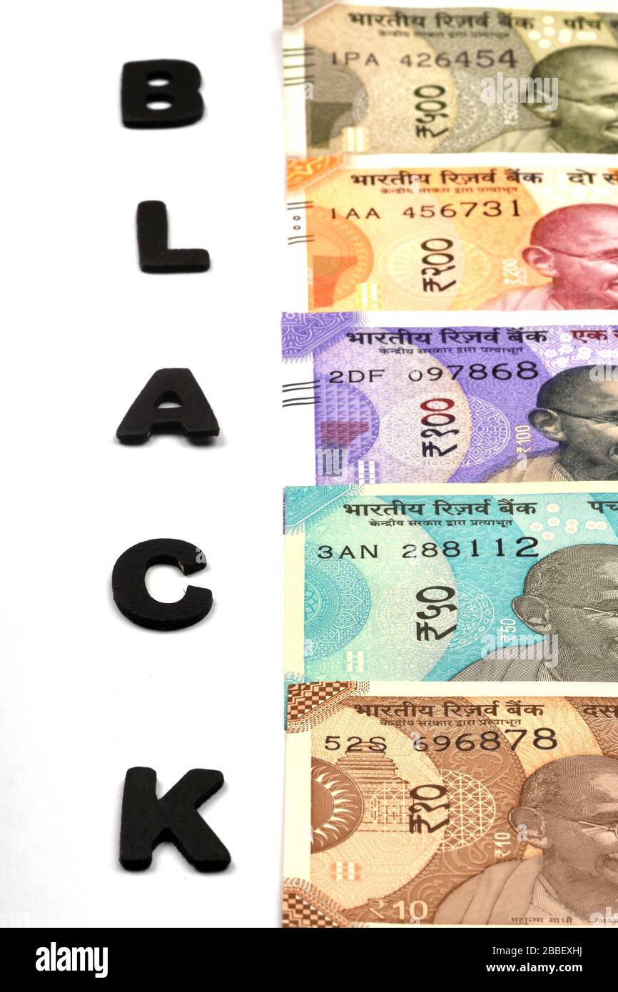 Black money concept,black alphabet on money background,Indian Currency, Rupee, Indian Rupee,Indian Money, Business, finance, and corruption concept Stock Photo
