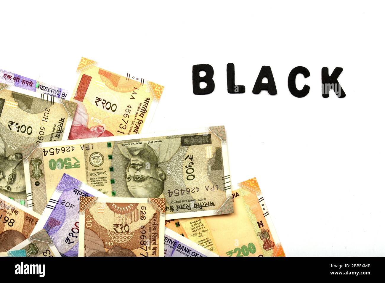 Black money concept,black alphabet on money background,Indian Currency, Rupee, Indian Rupee,Indian Money, Business, finance, and corruption concept Stock Photo