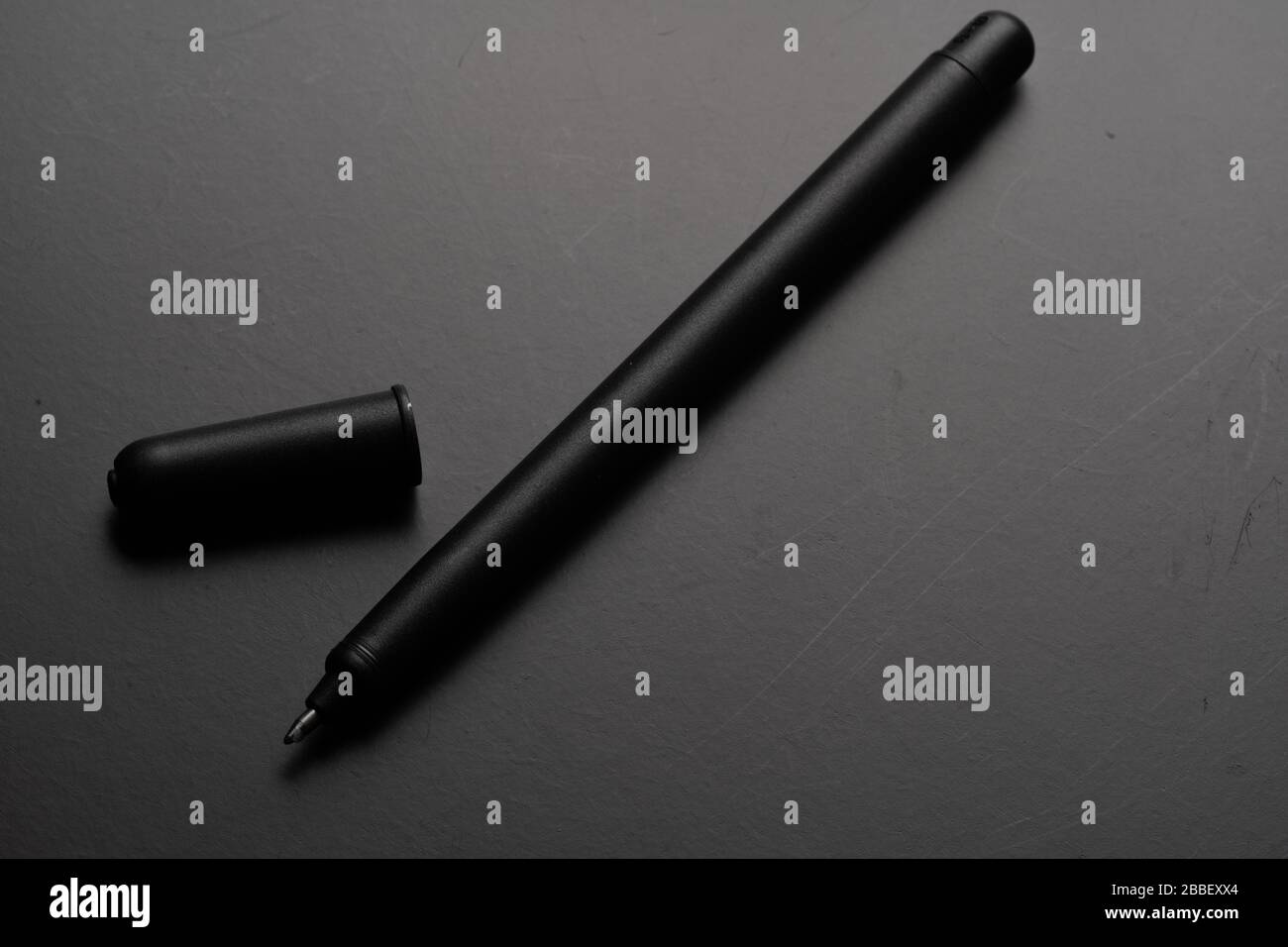 A black pen. Isolated on black background Stock Photo - Alamy