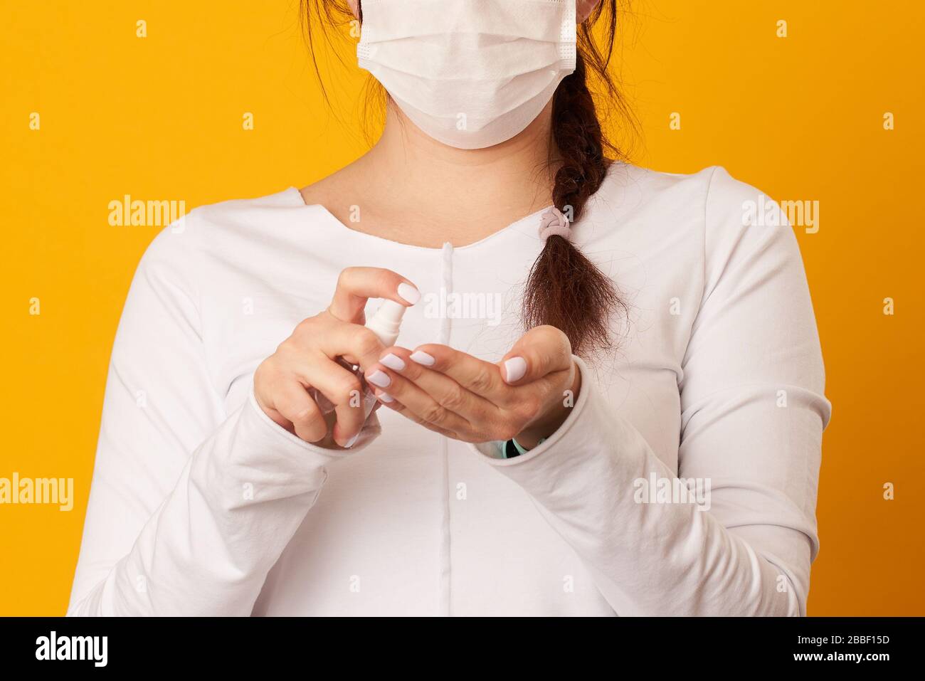 Woman is using antiseptic for hands. Concept of hygiene, protect of virus. Covid-19 Corona Prevention Measures. Stock Photo