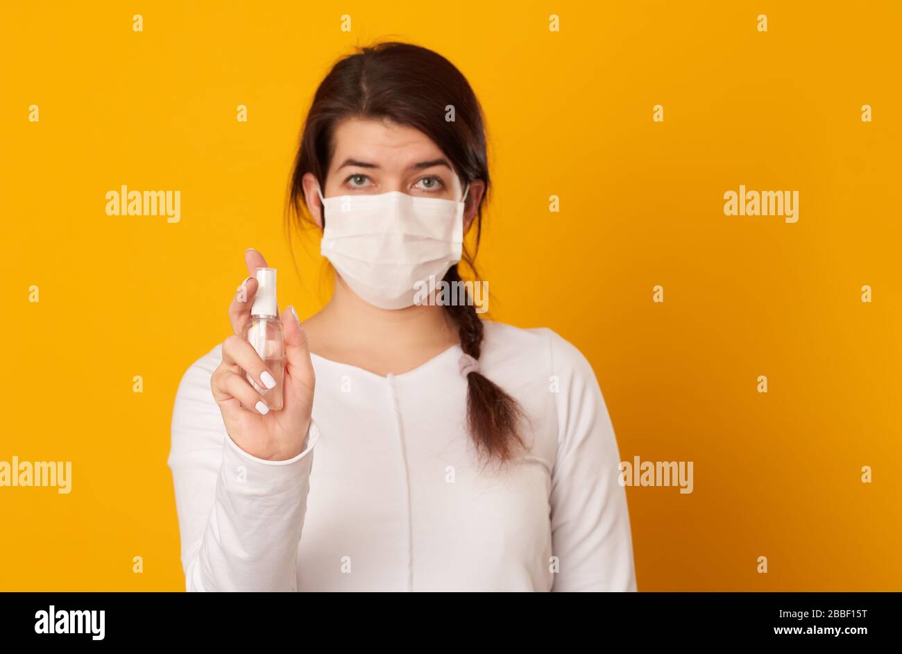 Woman holds antiseptic in her hands. Concept of hygiene, protect of virus. Covid-19 Corona Prevention Measures. Stock Photo