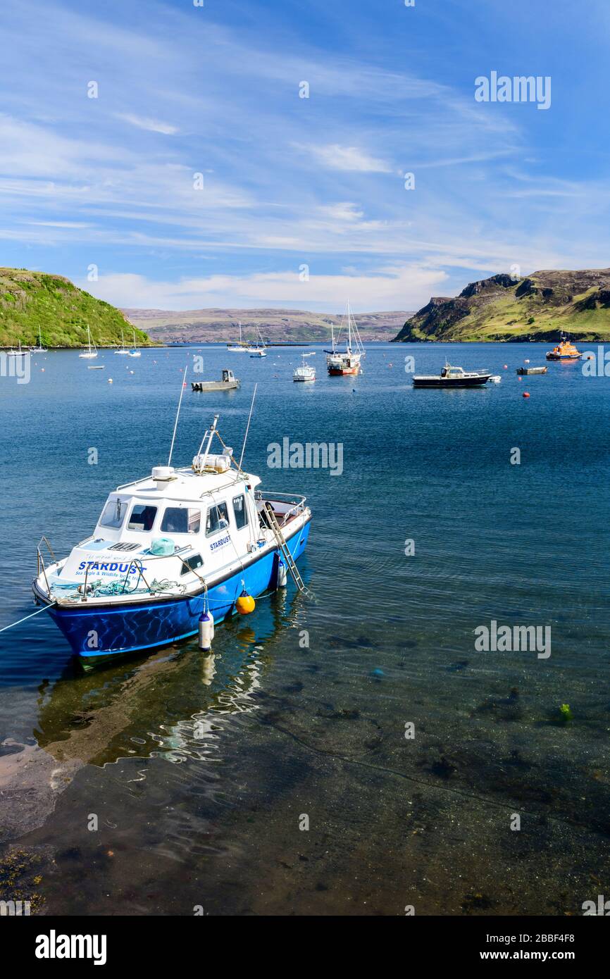 A boat is anchored in the harbour at Portree on the Isle of Skye in Scotland. Stock Photo
