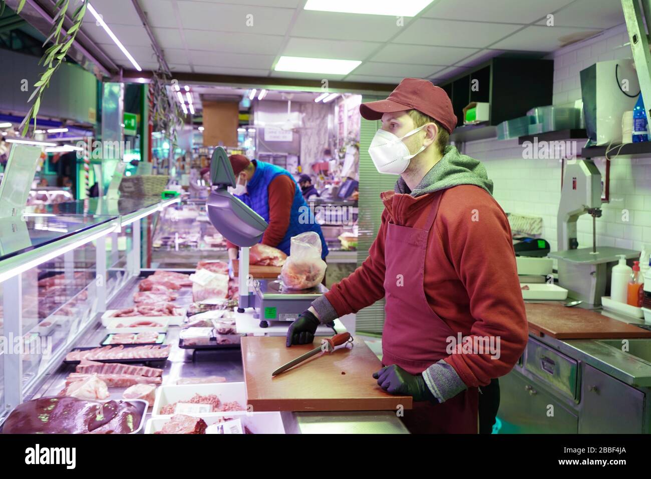 A butcher wearing a coronavirus protective mask. Turin, Italy - March 2020 Stock Photo