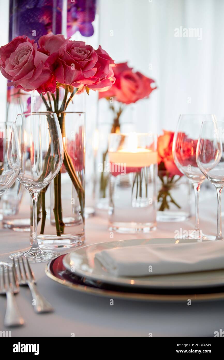 restaurant dinner party table setting roses plate glasses big window Stock Photo