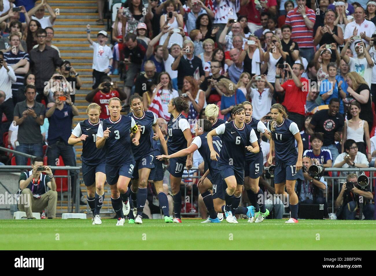 Carli LLOYD of USA scores the first goal and celebrates with her team