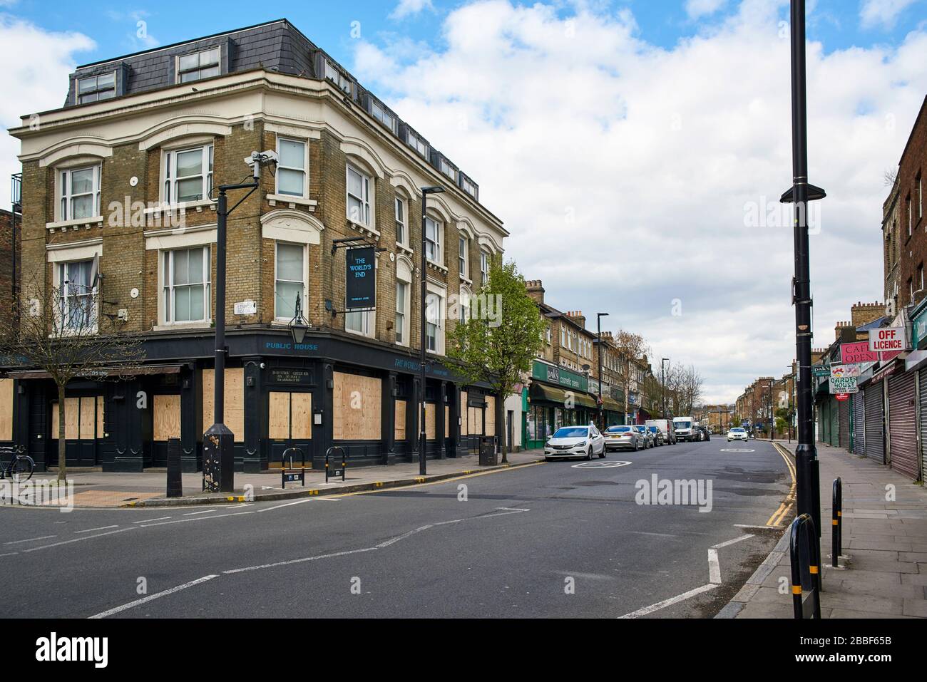 Stroud Green Road, Finsbury Park, North London UK, during the coronavirus crisis, with the boarded up World's End pub and closed shops Stock Photo