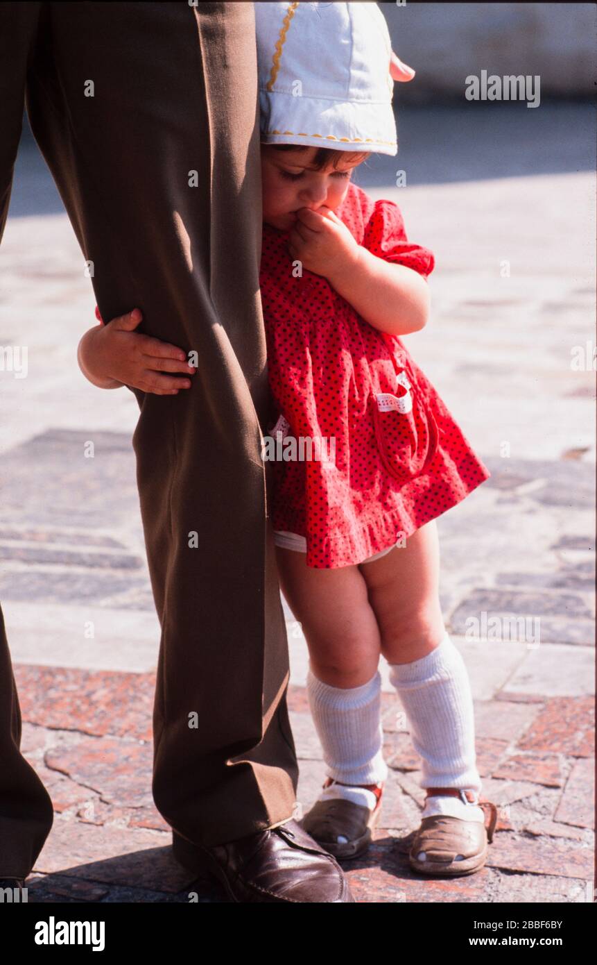 A young girl clings to her father's leg, Victory Day, Moscow, May 9th 1990. Stock Photo