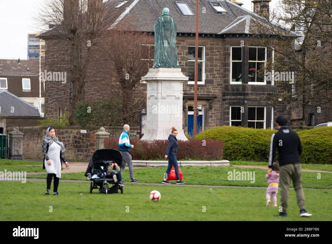 Edinburgh, Scotland, UK. 31 March, 2020. Police patrol public parks and walking areas to enforce the coronavirus lockdown regulations about being outdoor. Family outside in Victoria Park playing football. Iain Masterton/Alamy Live News Stock Photo