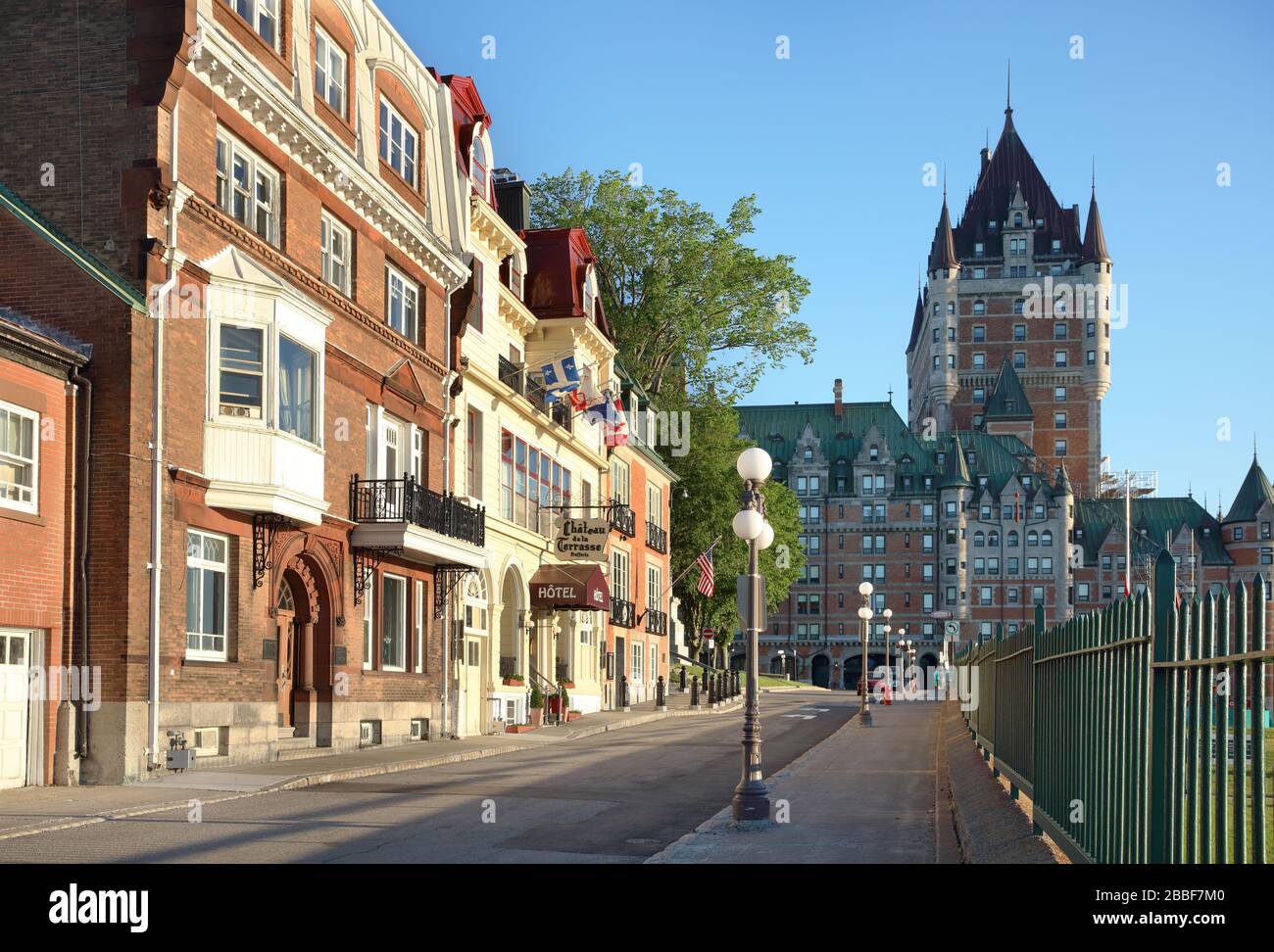 Lit up by the early morning light on Place Terrasse Dufferin is an assortment of residences, a small hôtel and the U.S. Consulate. At the end of the street is the iconic Chateau Frontenac, Quebec City, Province of Quebec, Canada Stock Photo