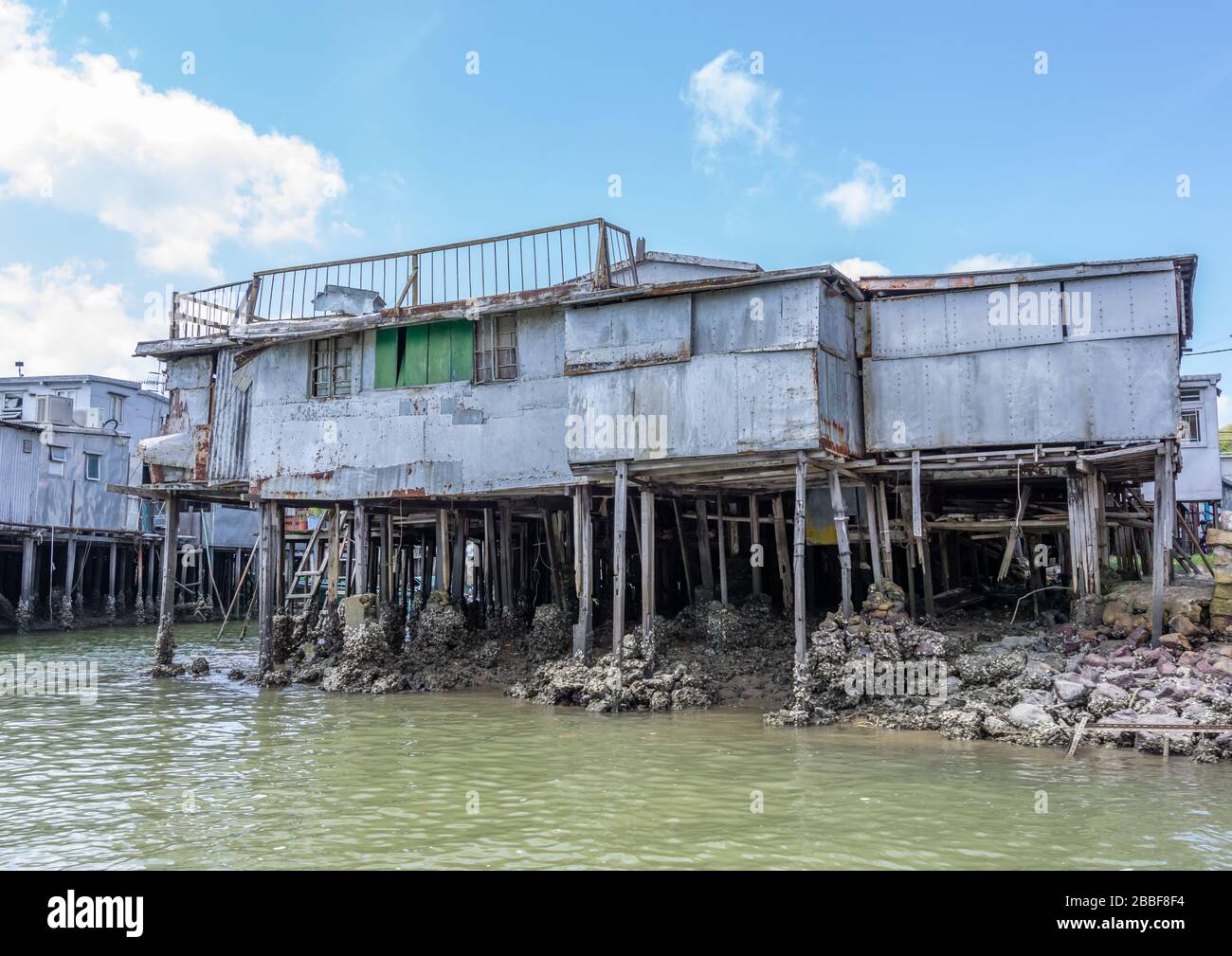 Old crumbling house on stilts over water in Hong Kong Stock Photo Alamy