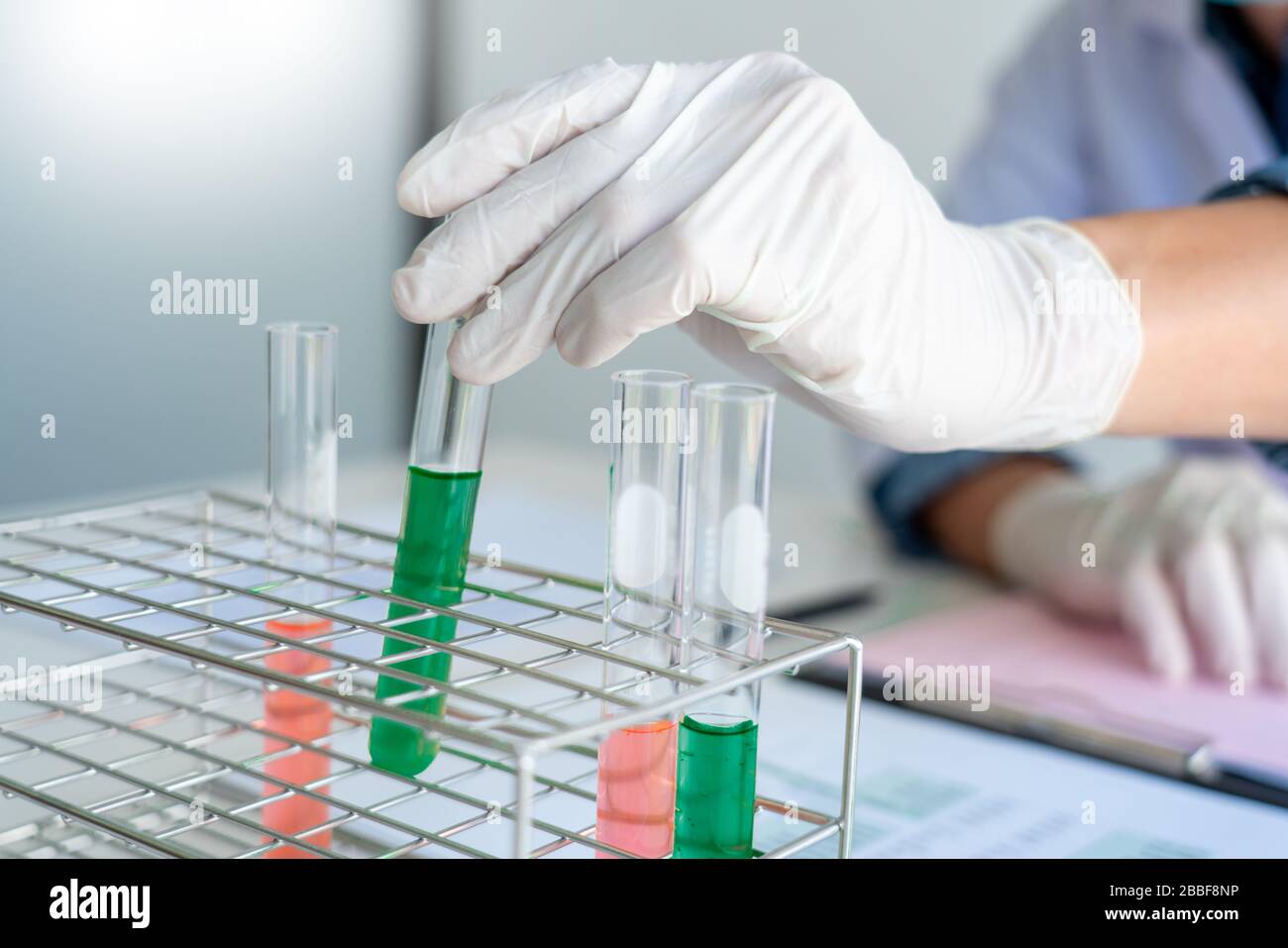 Scientist wear lab coat and protective wear are working with research