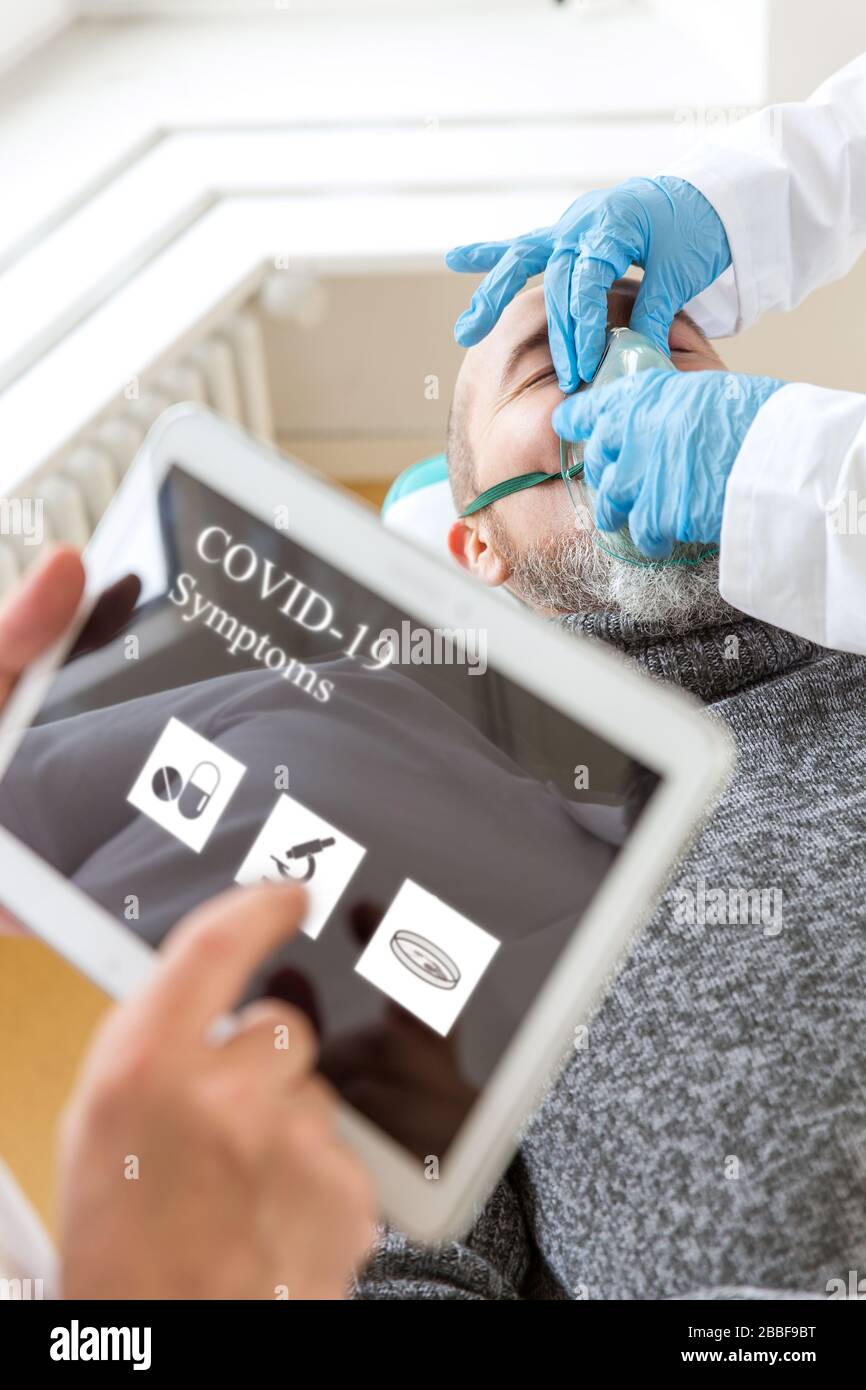 male patient with respirator, doctor is holding a tablet, corona virus concept or covid-19, sars-cov-2 Stock Photo