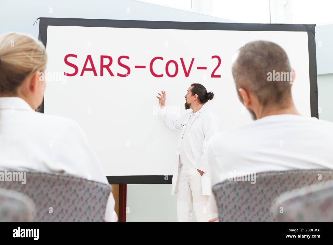a conference or meeting with brainstorming of a group of hospital staff or scientists, concept corona virus or covid-19, sars-cov-2 Stock Photo