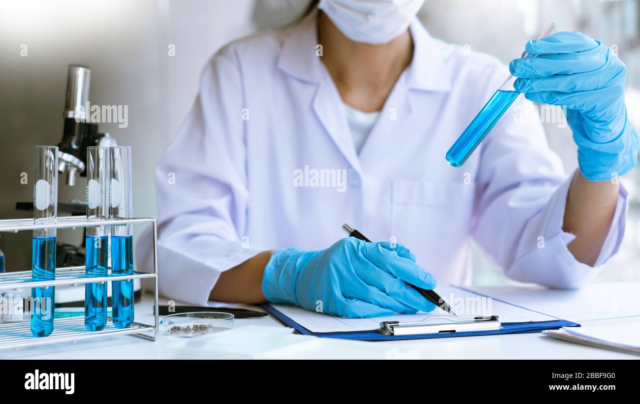 Scientist wear lab coat and protective wear are working with research