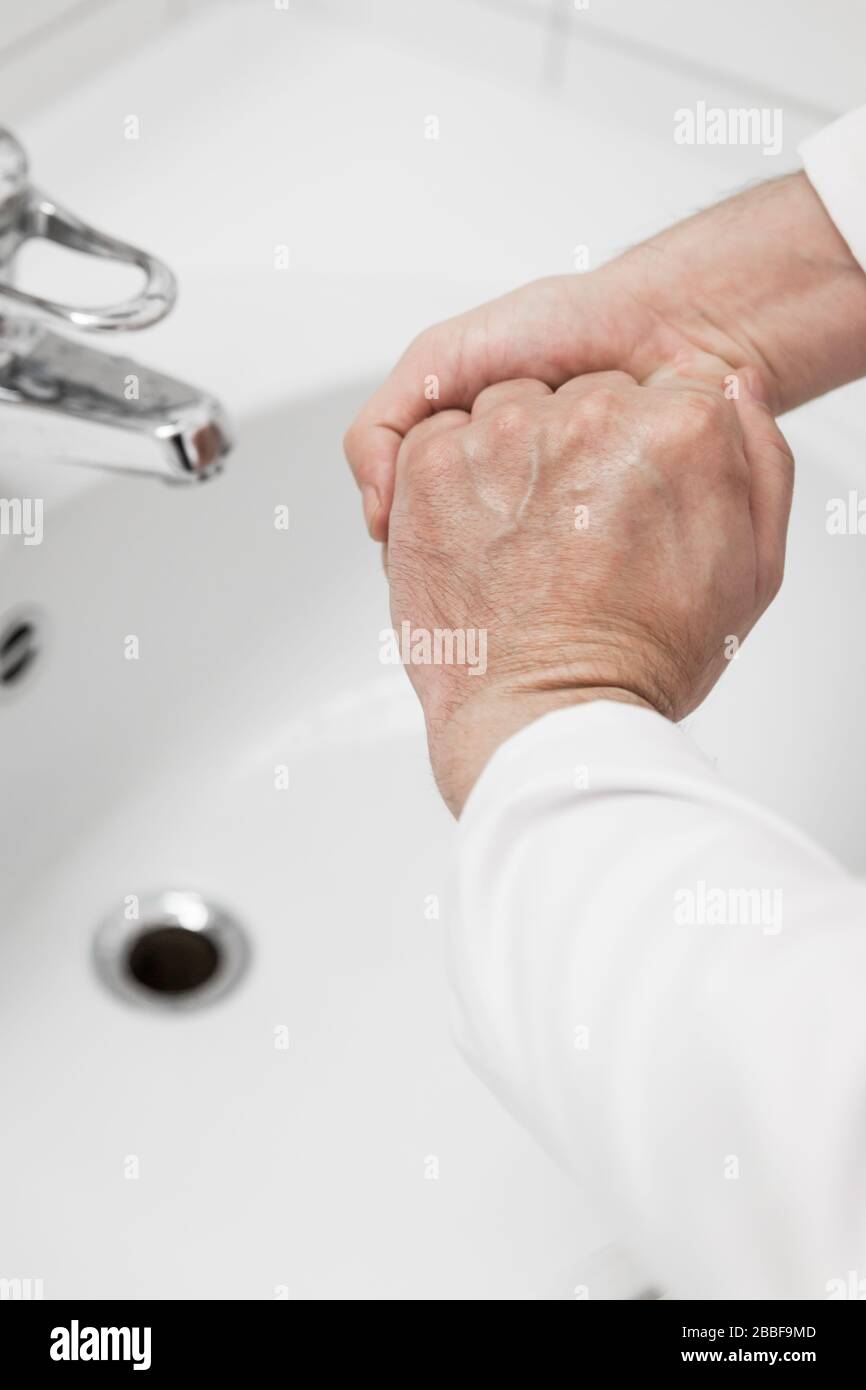male doctor is washing his hands with soap, then he uses desinfection liquid, corona virus concept or covid-19, sars-cov-2 Stock Photo