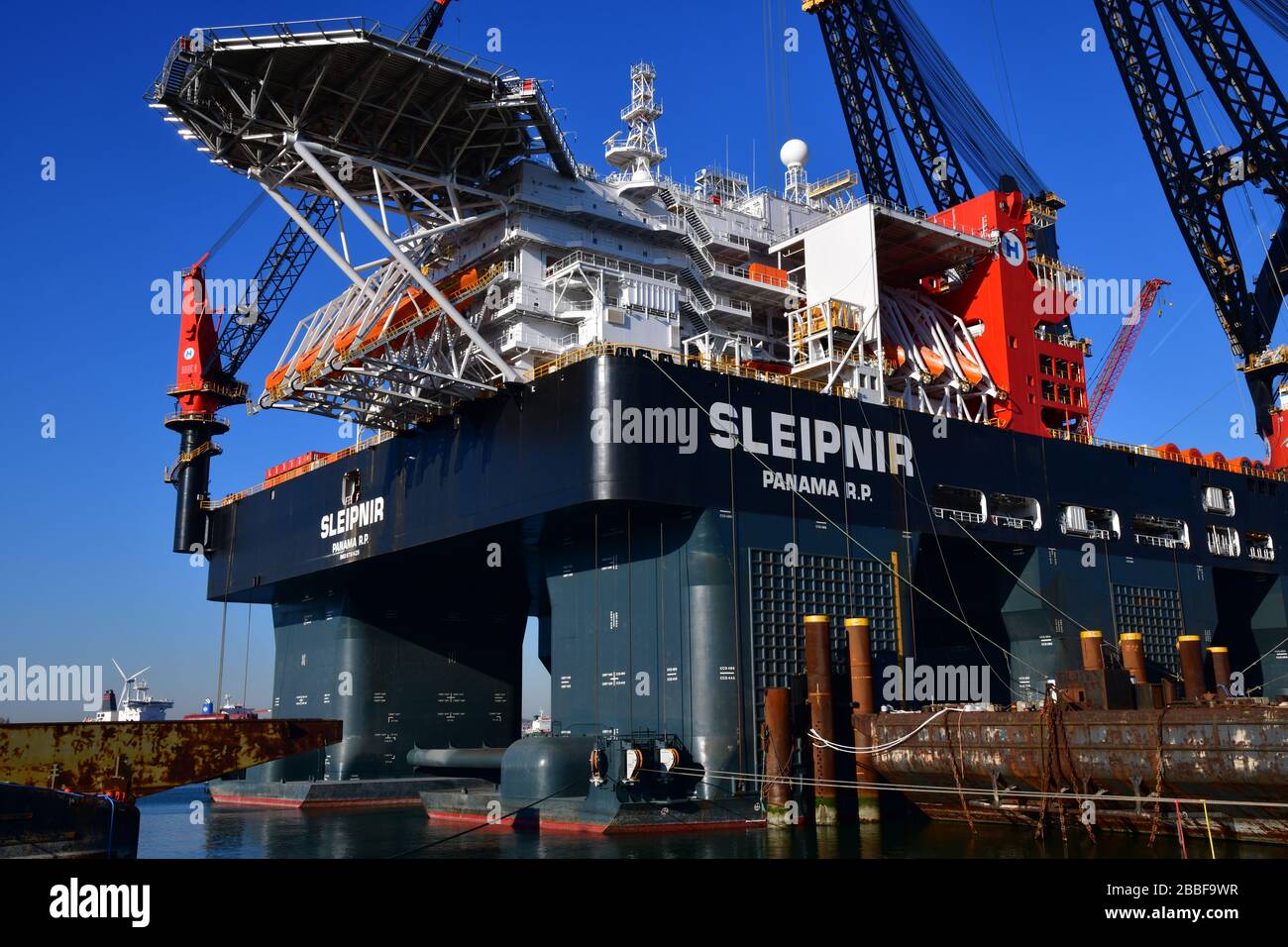 Rotterdam, The Netherlands-March 2020: Close up view section of docked offshore platform, largest crane vessel in the world (Sleipnir) with production Stock Photo
