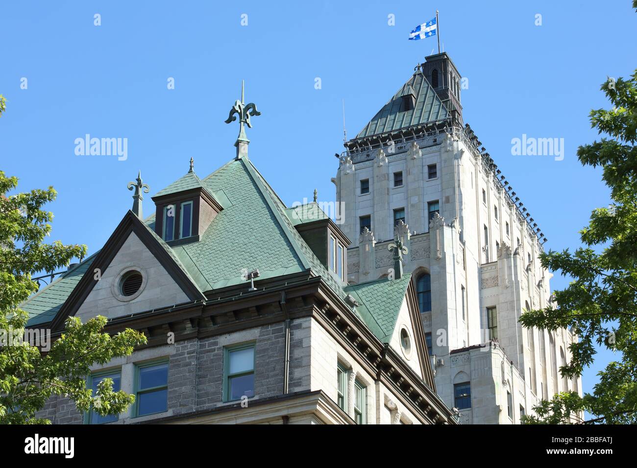 Architectural details of two rooftops: Art Deco-style Price Building in the background and the Second Empire-style of Quebec's City Hall in the foreground, Upper Town, Old Quebec City, Province of Quebec, Canada Stock Photo