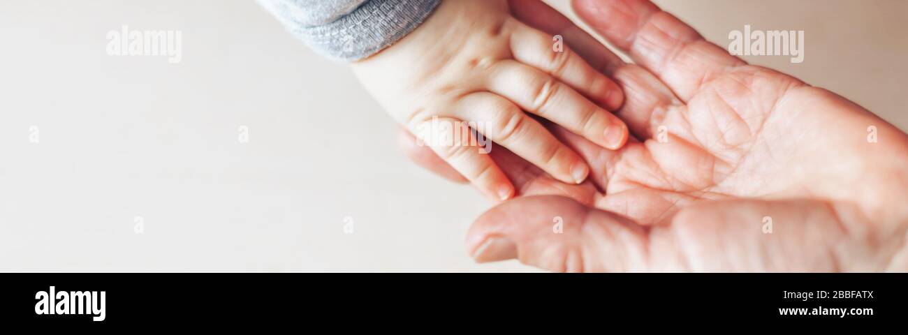 An old woman and a kid holding hands together Stock Photo - Alamy