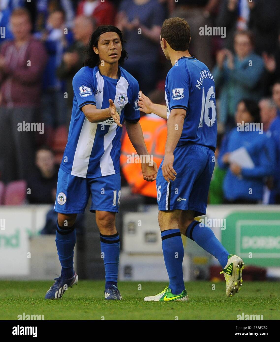 Wigan Athletic's Roger Espinoza (left) is congratulated by James McArthur after scoring the opening goal against Swansea City. Stock Photo