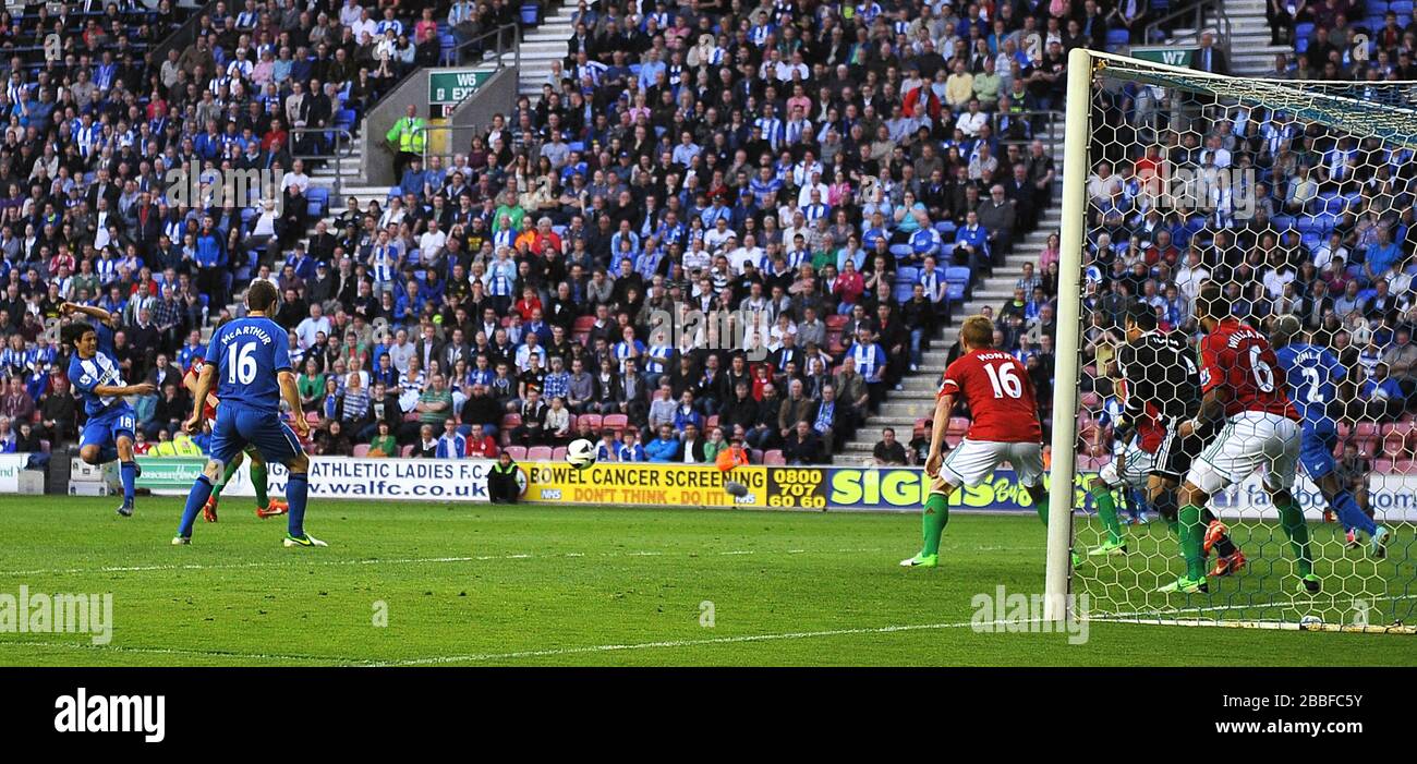 Wigan Athletic's Roger Espinoza (far left) scores the opening goal of the game against Swansea City. Stock Photo