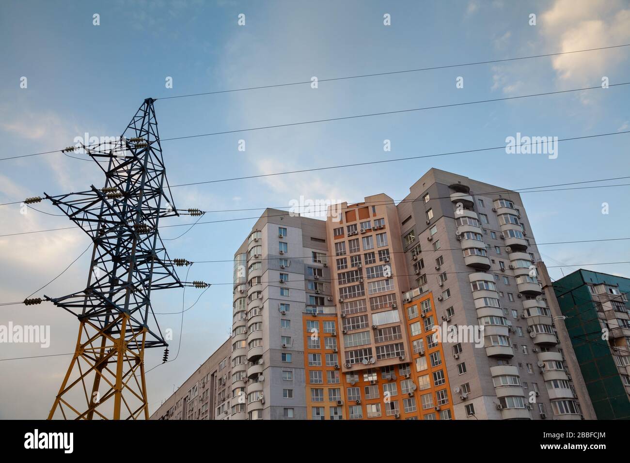 Highvoltage networks, residential buildings against the evening sky