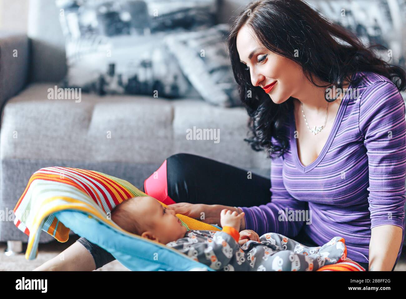 beautiful mother with newborn cute baby at home Stock Photo