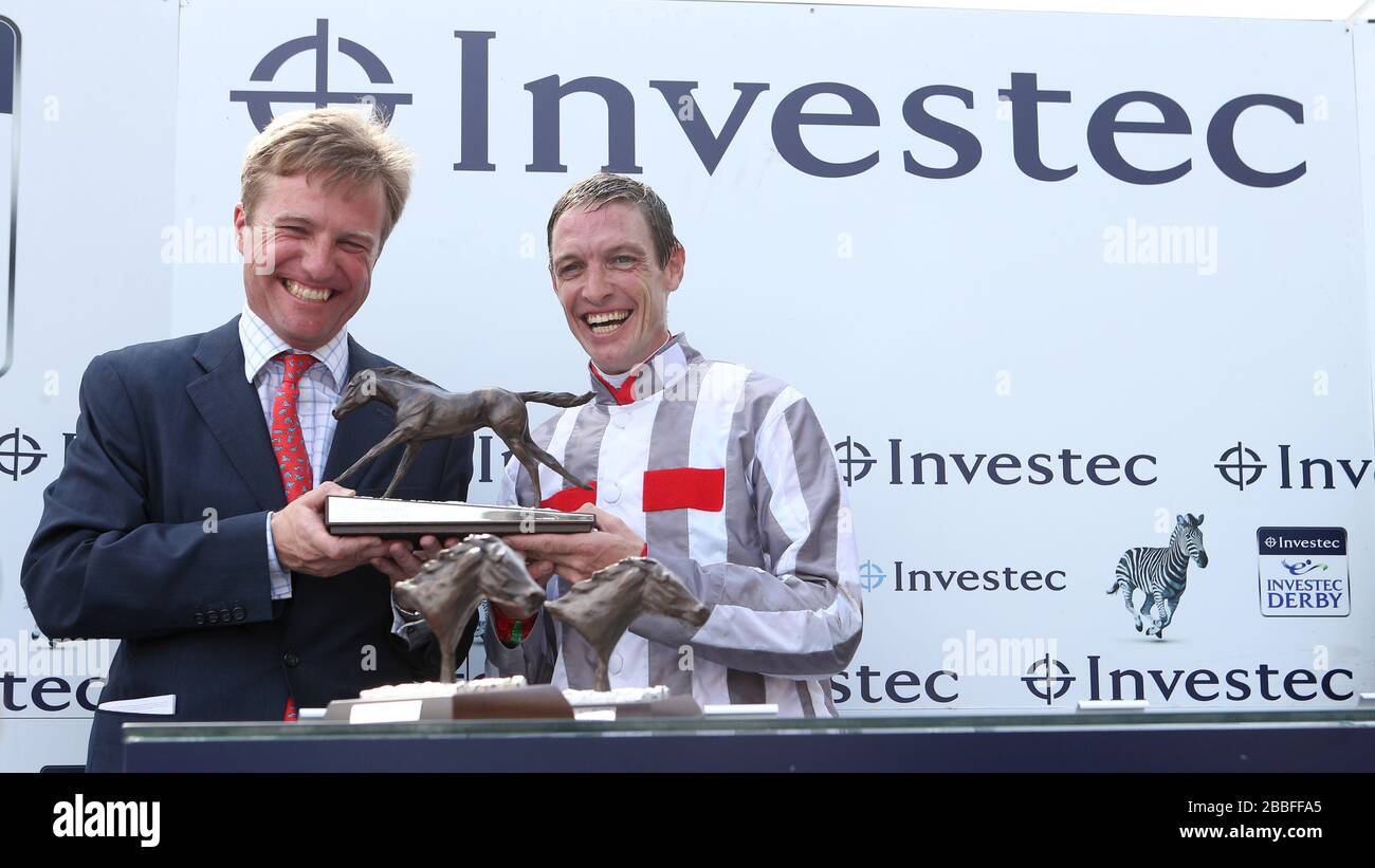 Jockey Richard Hughes (right) and trainer Ralph Beckett (left) celebrate with the trophy after winning The Investec Oaks with Talent Stock Photo