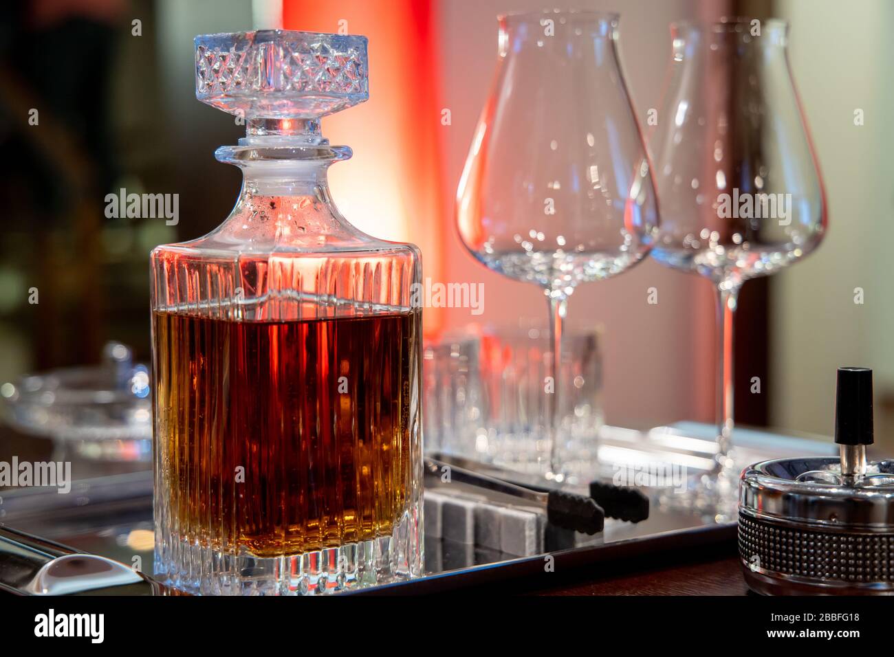 cognac in a decanter with glasses on the table Stock Photo Alamy