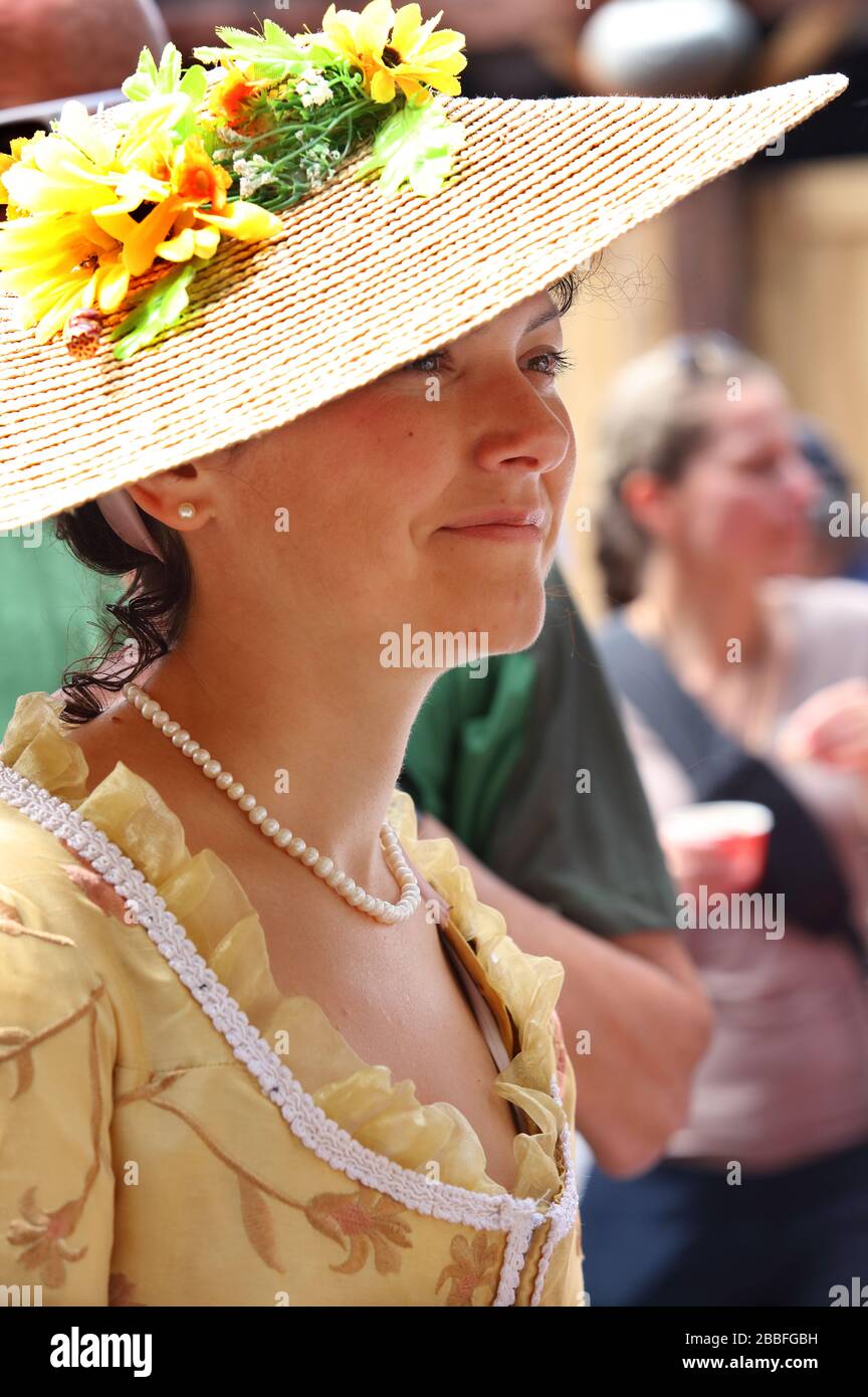 Young woman wearing a late 18th century, English-style brocated gown and French-style straw hat during activities held at the Fetes de la Nouvelle-France (New France Festival), Quebec City, Province of Quebec, Canada Stock Photo
