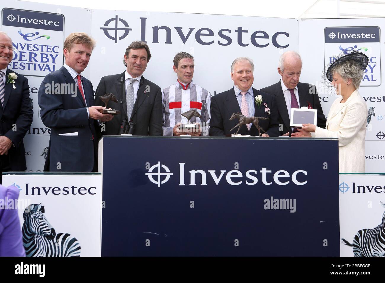 Winners presentation for the Investec Oaks including trainer Ralph Beckett (far left) and jockey Richard Hughes (centre) Stock Photo
