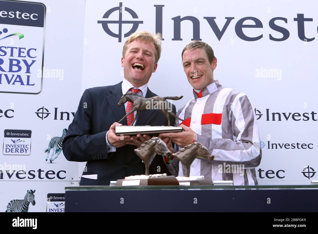 Jockey Richard Hughes (right) and trainer Ralph Beckett (left) celebrate with the trophy after winning The Investec Oaks with Talent Stock Photo