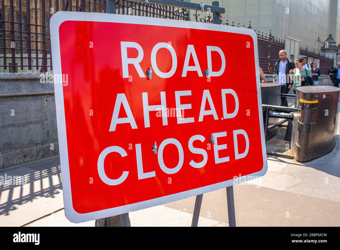 Close up of red ROAD AHEAD CLOSED sign on Westminster Bridge looking down towards Parliament Square, London. Stock Photo