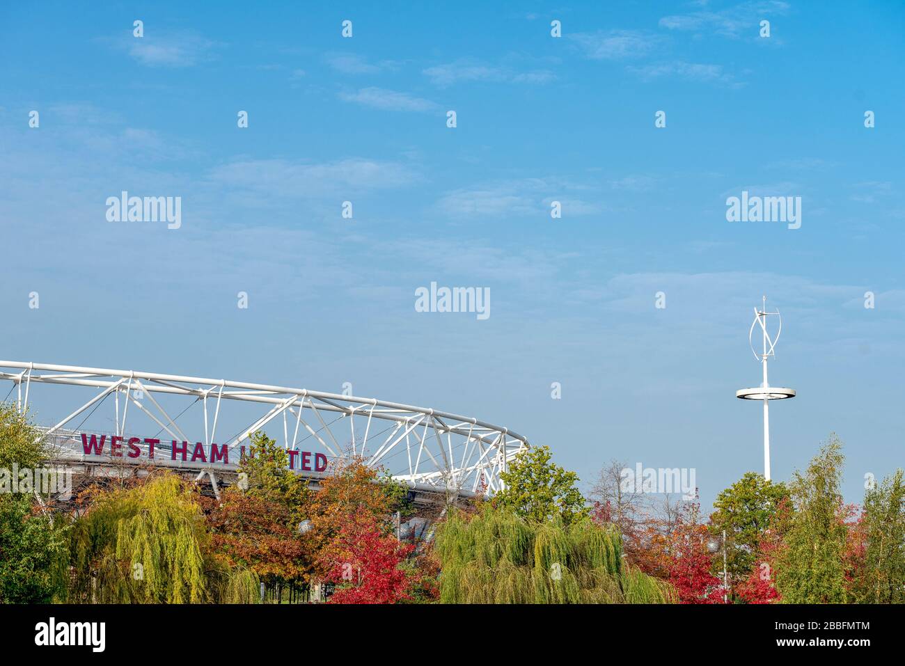 West Ham United's Home ground and former 2012 olympic stadium The London Stadium, visible through autumn trees in the Queen Elizabeth Olympic Park Stock Photo
