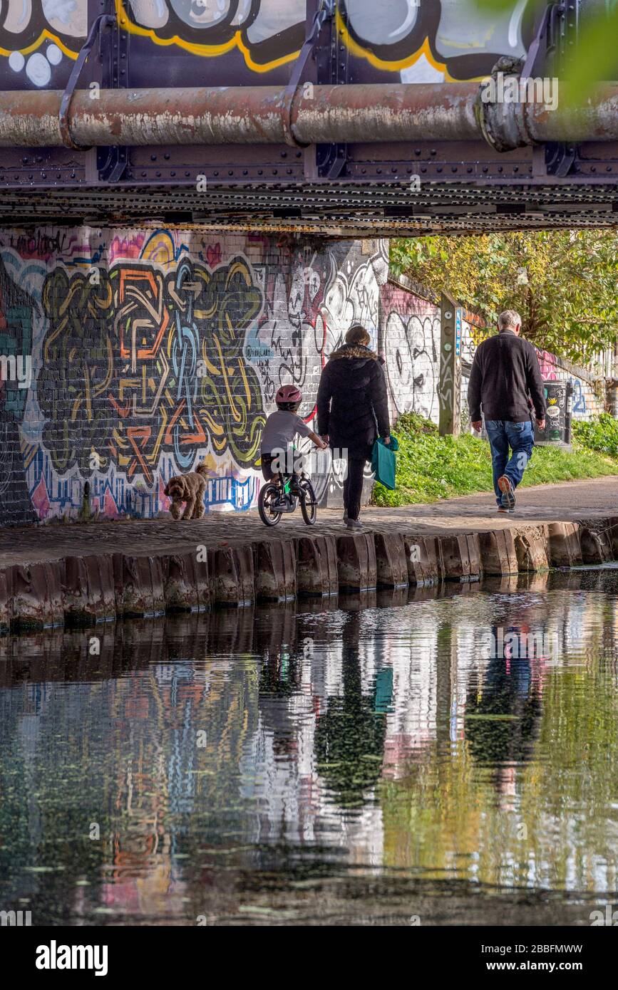 A young family stroll along The River Lea in Hackney Wick East London, UK Stock Photo