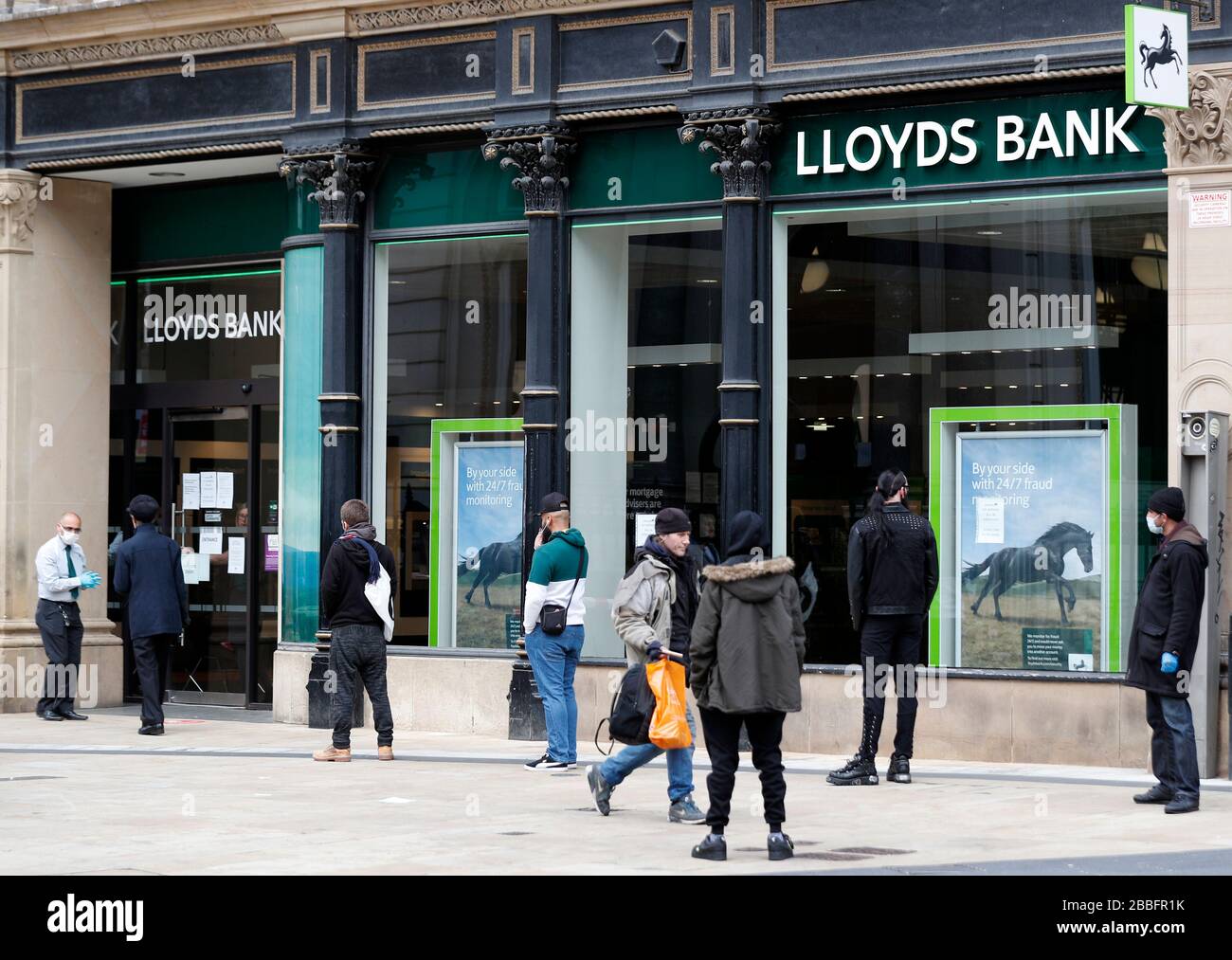 Birmingham, West Midlands, UK. 31st March 2020.  Customers practice social distancing as they wait to enter Lloyds Bank in Birmingham city centre during the Coronavirus pandemic lockdown. Credit Darren Staples/Alamy Live News. Stock Photo