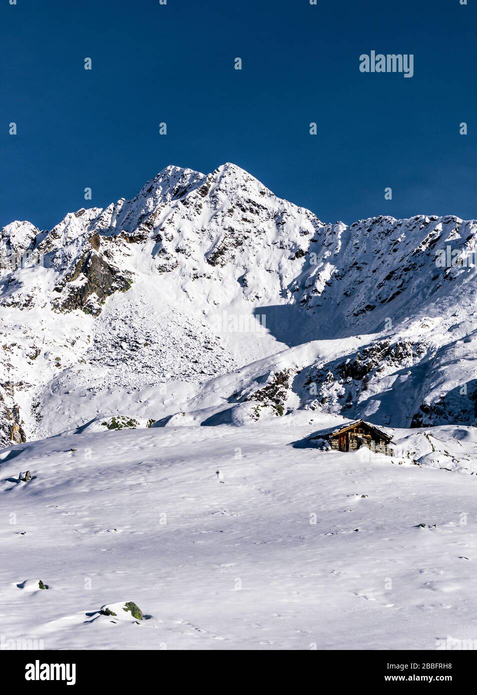 The mountains of Tartano Valley, near the town of Morbegno, Italy, during a beautiful winter day Stock Photo