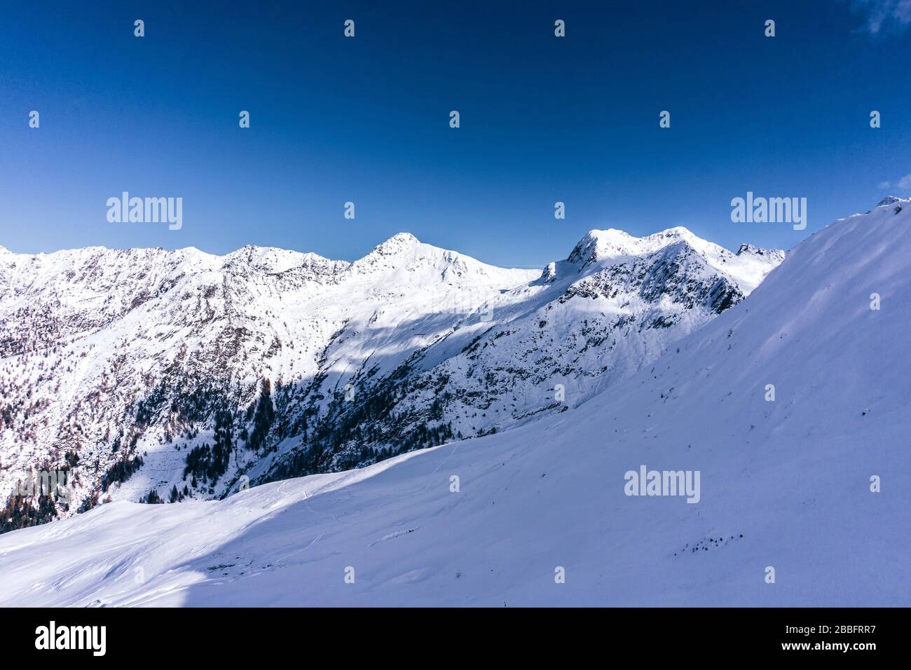 The mountains of Tartano Valley, near the town of Morbegno, Italy, during a beautiful winter day Stock Photo