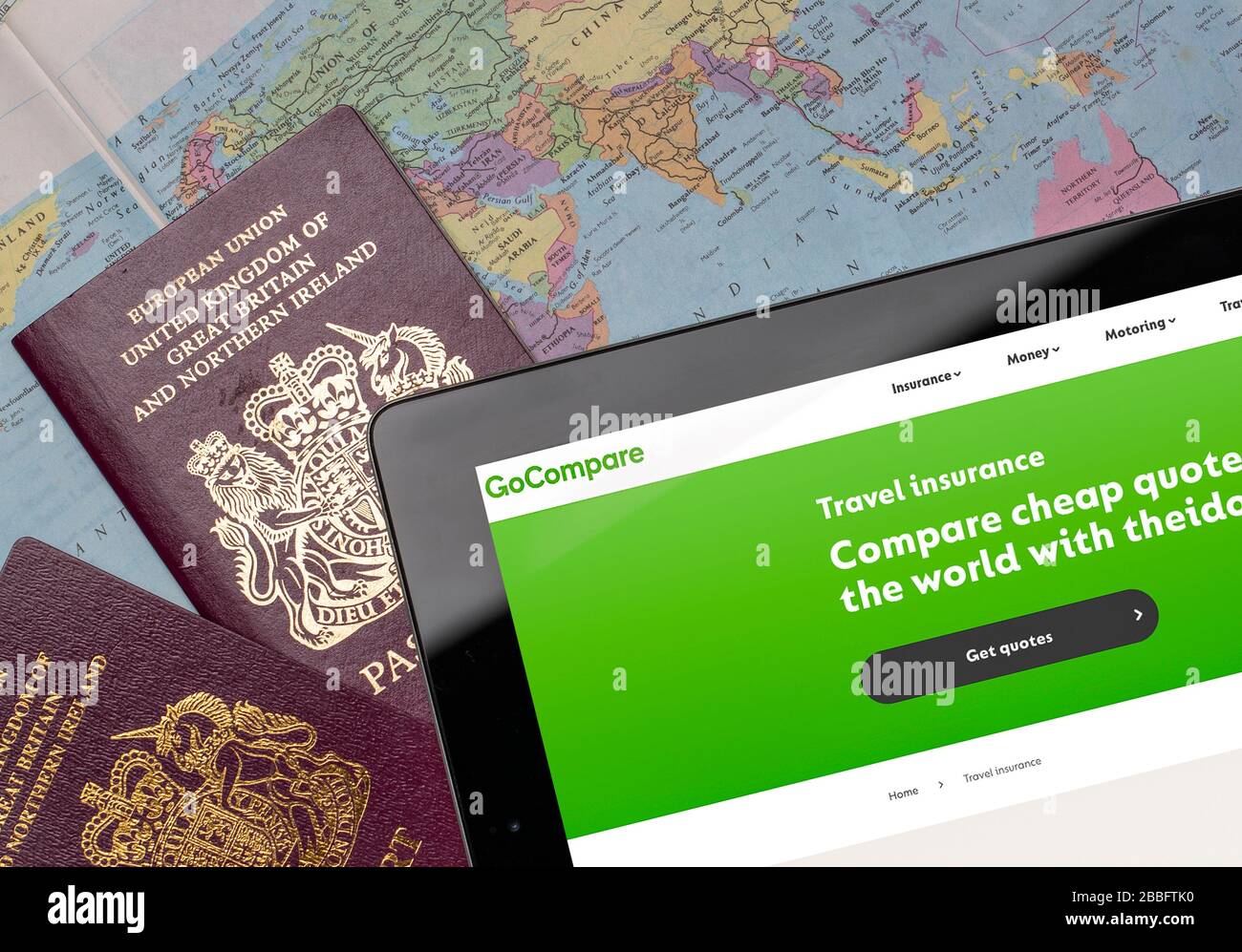 GoCompare Travel insurance comparison website on an iPad or tablet. (editorial use only) Stock Photo