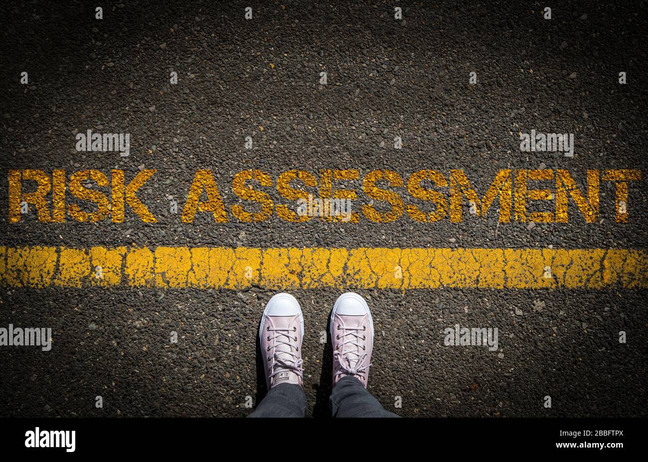 Risk Assessment concept image of someone considering the risk before crossing the line Stock Photo