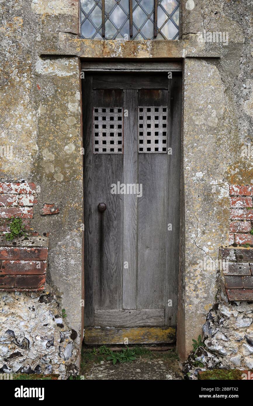 Narrow door on exterior of St John the Baptist church in Doddington in Kent, England Stock Photo