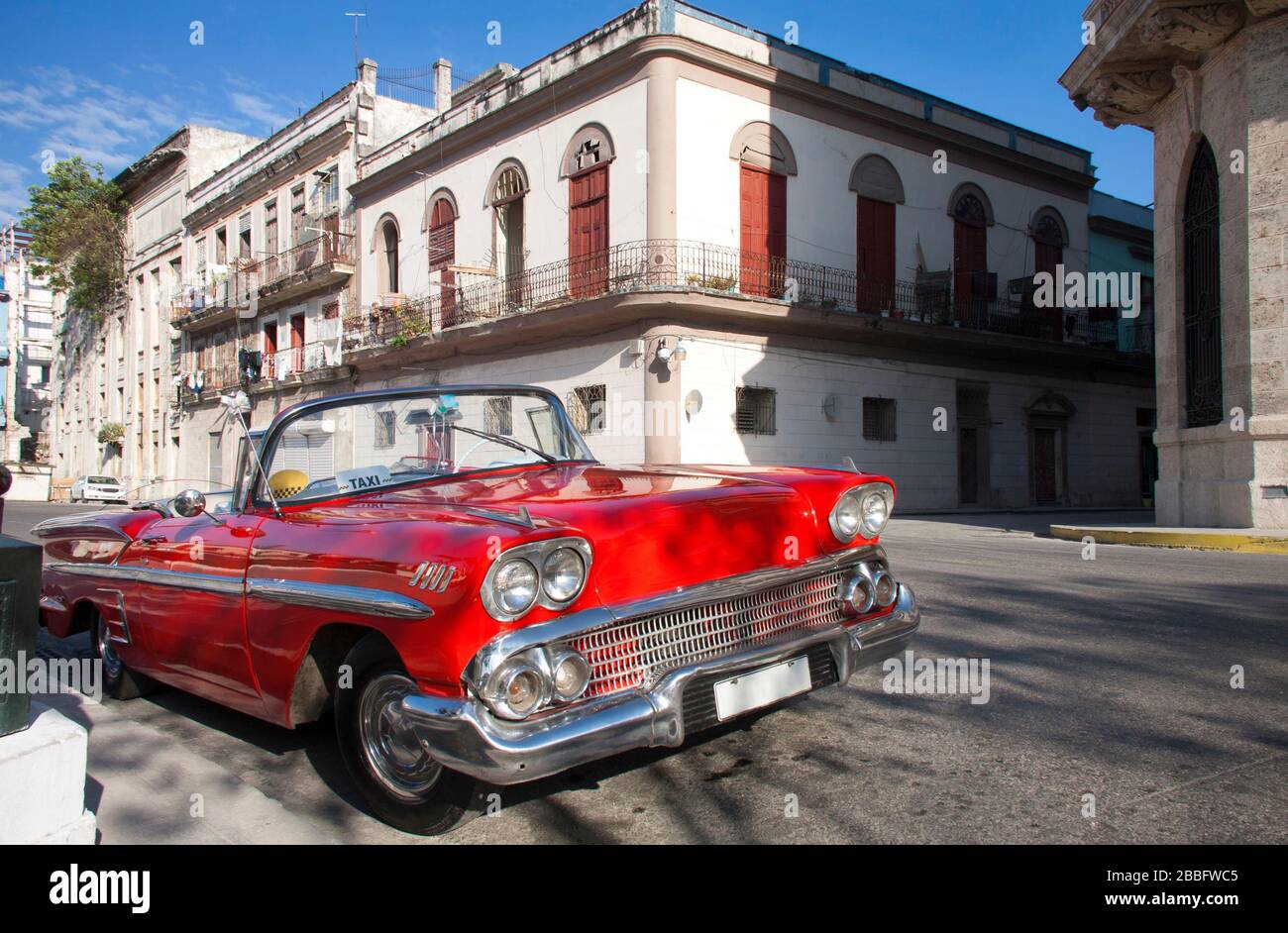 HAVANA, CUBA - MARCH 29, 2017: Beautiful red convertible 50s American car parked on the street near to the Capitol. Havana, Cuba. Travels and tourism. Stock Photo