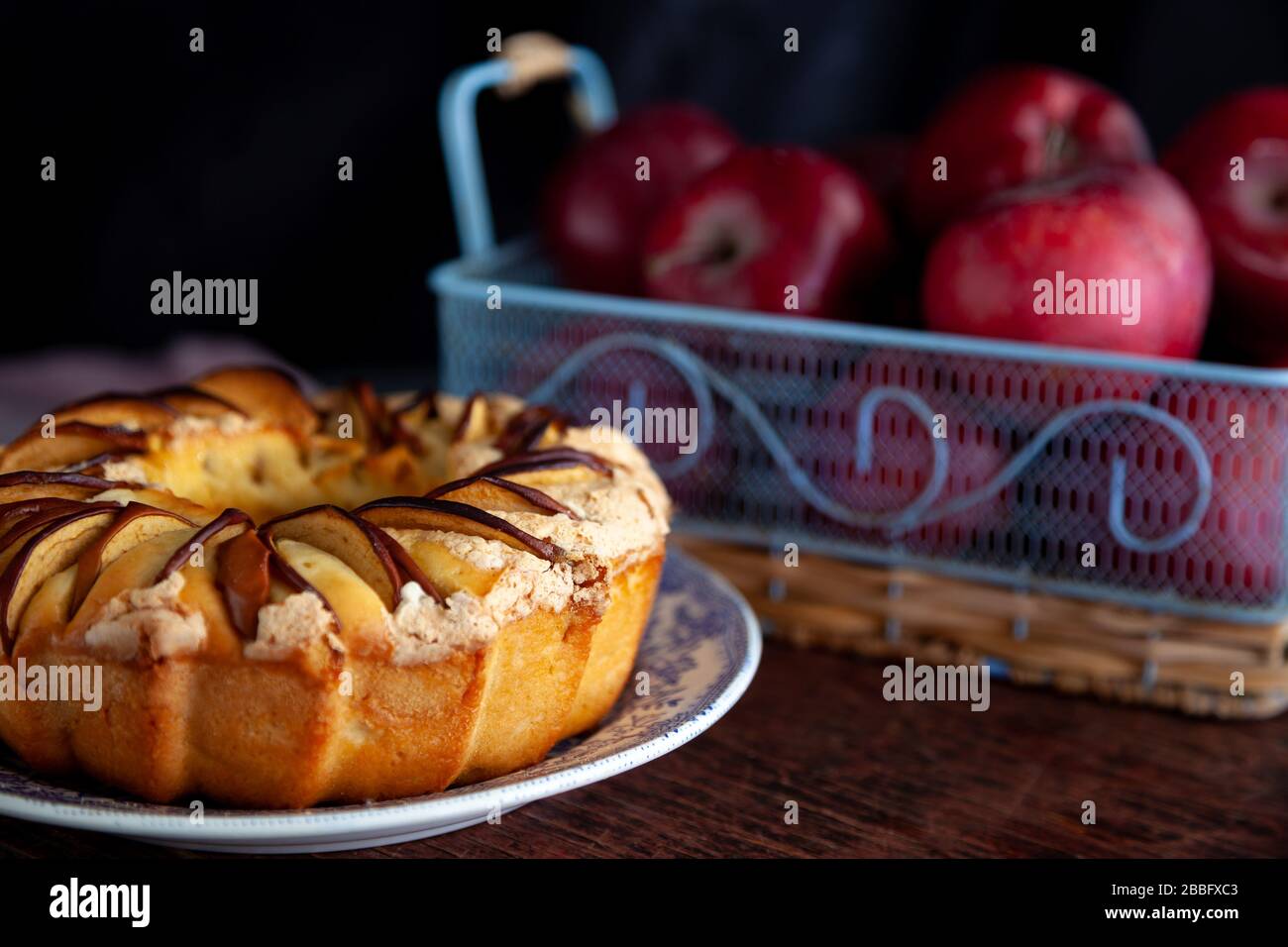 Round apple pie. Homemade pastries. Cupcake with apples on a wooden table. Simple food. Stock Photo