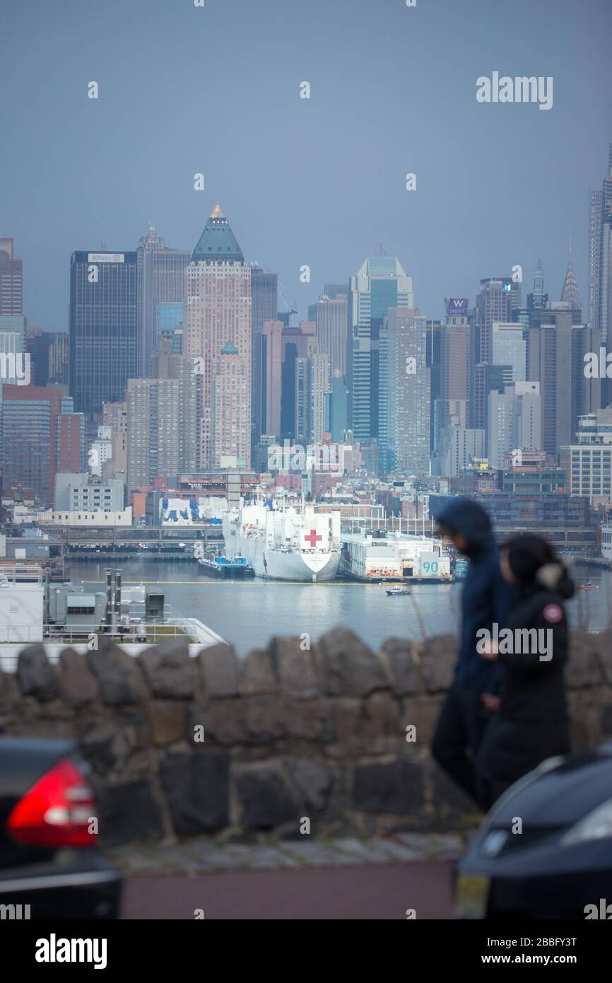 USNS Comfort U.S. Navy Hospital Ship docked in New York City Pier 90 ready to take on new patients while NYC is under Quarantine and help relief Stock Photo