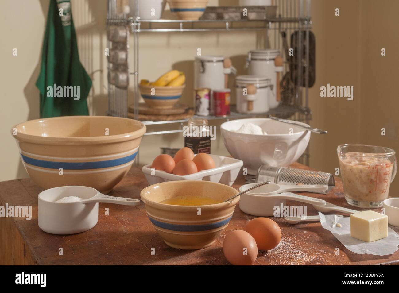 Ingredients for making banana bread on butcher block in kitchen. Stock Photo