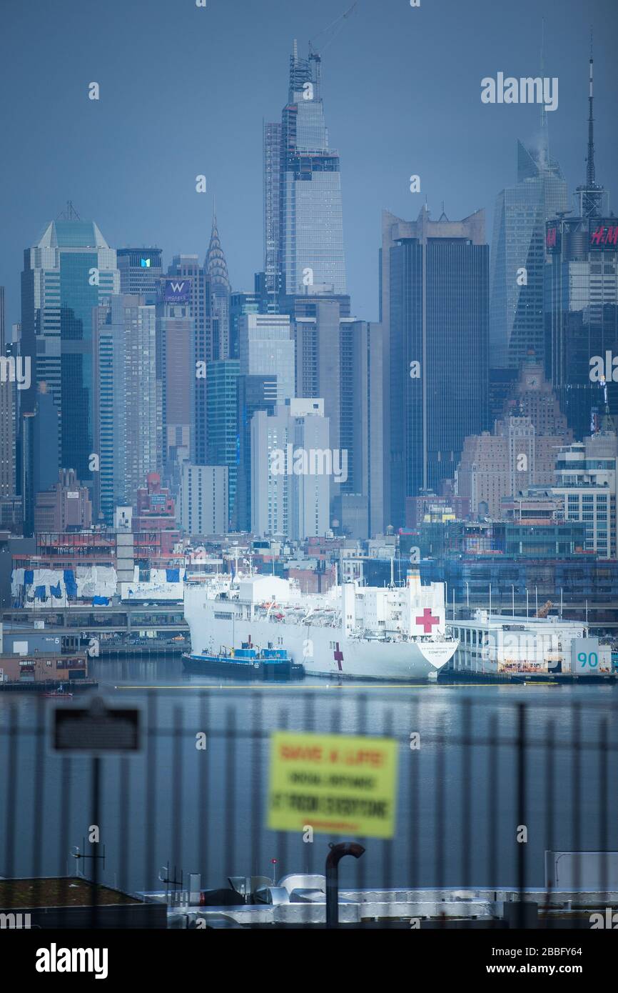 USNS Comfort U.S. Navy Hospital Ship docked in New York City Pier 90 ready to take on new patients while NYC is under Quarantine and help relief Stock Photo
