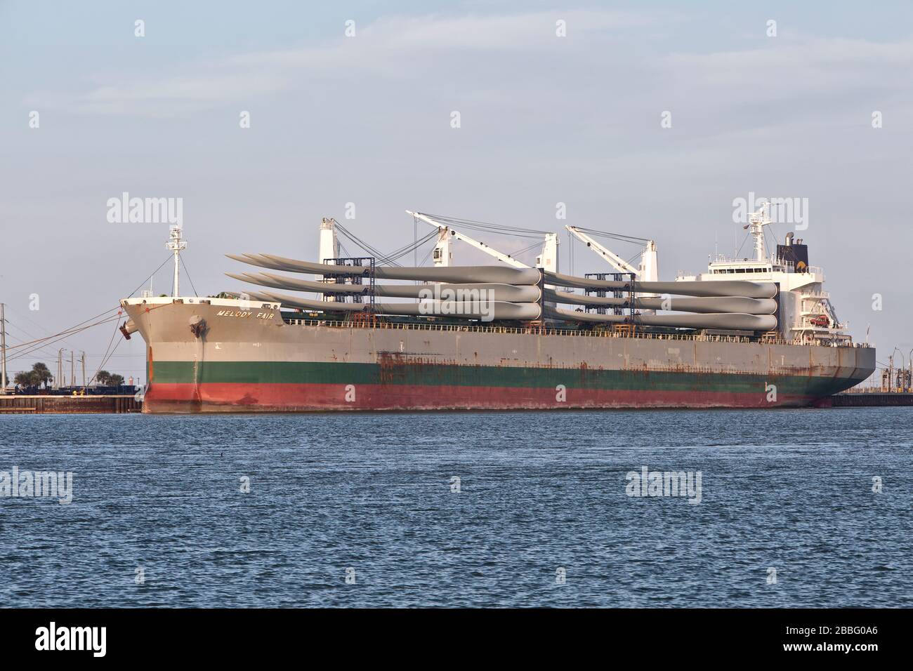 Giant Wind Turbine Propeller Blades preparing to offload from freighter, pm light,   Port Aransas, Texas. Stock Photo